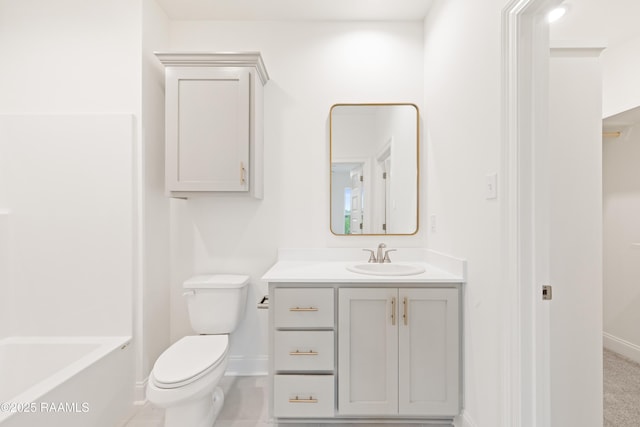 bathroom featuring toilet, vanity, and baseboards