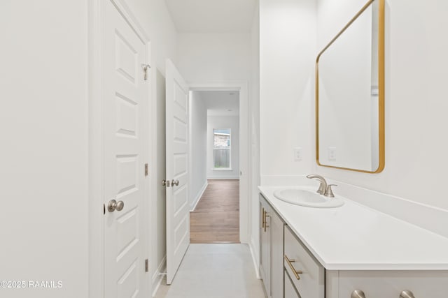 bathroom with vanity and baseboards