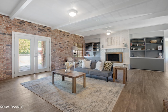 living area featuring brick wall and a wealth of natural light