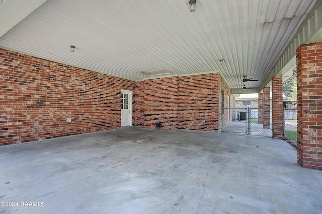 view of patio featuring a carport and a gate