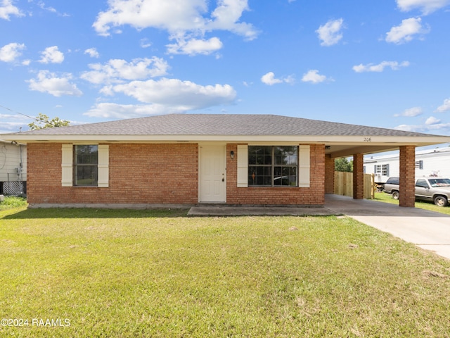 single story home featuring a carport and a front yard