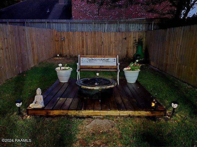 2345 Robley Dr, Lafayette, LA 70503 - wooden deck with a fire pit and a fenced backyard