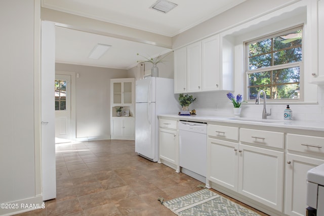 kitchen featuring backsplash, white cabinetry, sink, and white appliances