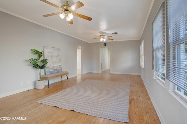 unfurnished room featuring hardwood / wood-style flooring, ceiling fan, and ornamental molding