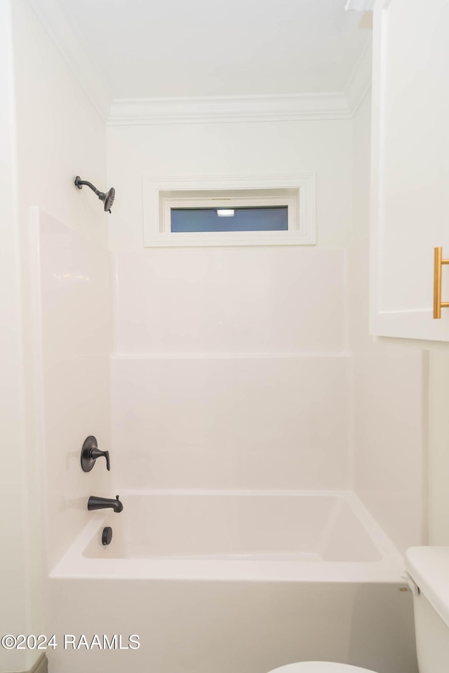 bathroom with toilet, washtub / shower combination, and crown molding