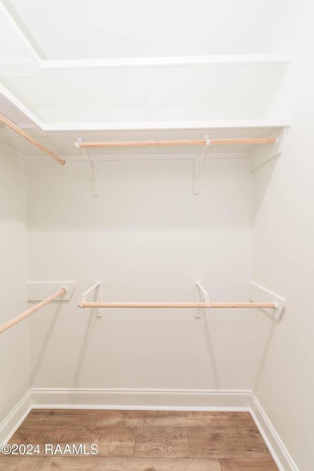 spacious closet featuring hardwood / wood-style floors