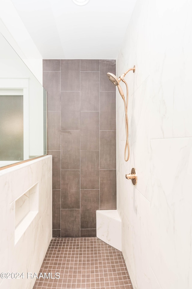 bathroom with a tile shower