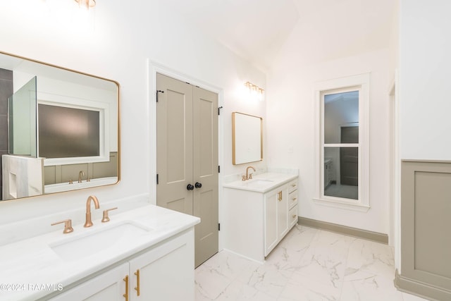 bathroom with vanity and vaulted ceiling