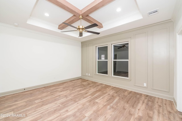 empty room featuring beamed ceiling, ornamental molding, light hardwood / wood-style flooring, and coffered ceiling