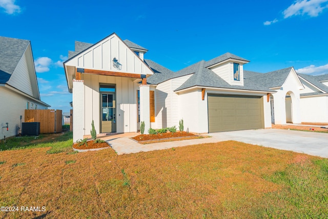 modern farmhouse style home featuring a garage, central air condition unit, and a front lawn