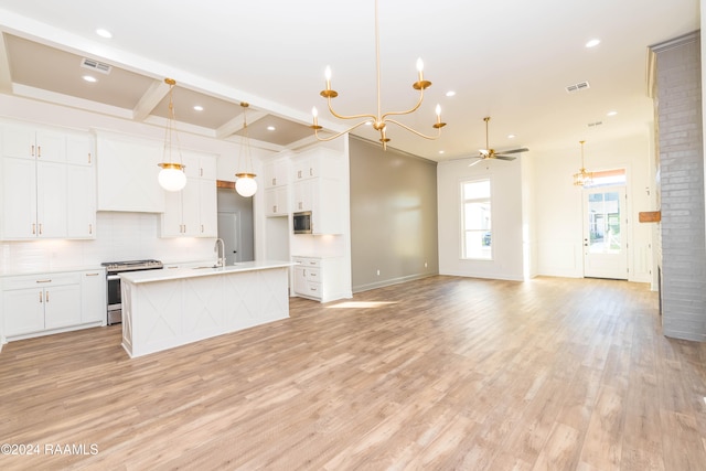 kitchen featuring white cabinetry, sink, stainless steel appliances, an island with sink, and ceiling fan with notable chandelier