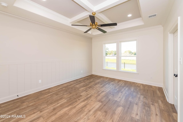 unfurnished room featuring coffered ceiling, hardwood / wood-style flooring, ceiling fan, ornamental molding, and beam ceiling