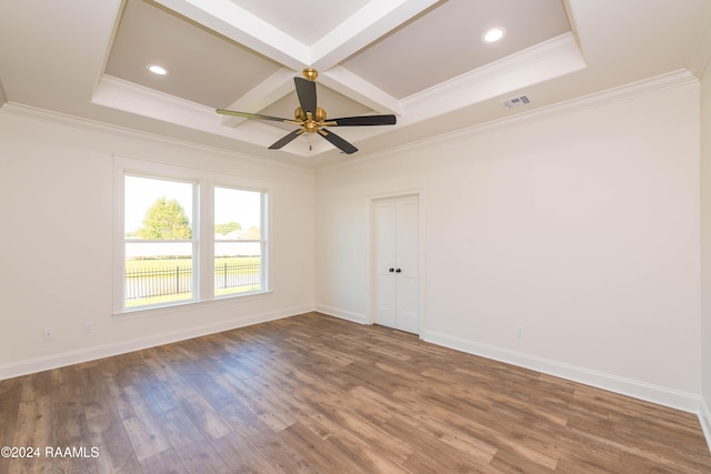 spare room featuring ceiling fan, coffered ceiling, dark hardwood / wood-style floors, and ornamental molding