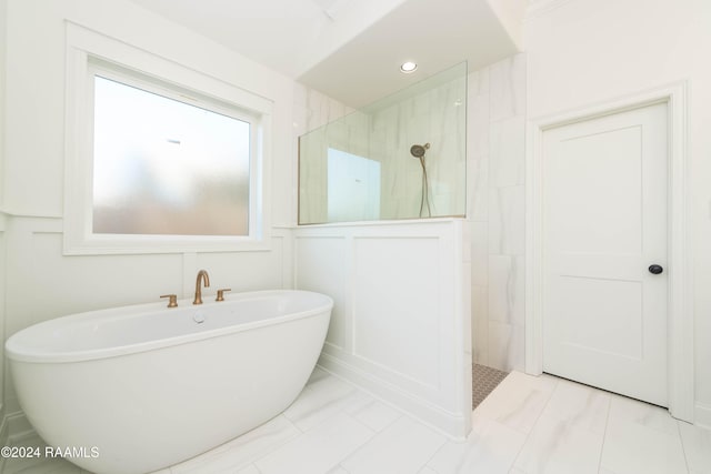 bathroom featuring tile patterned floors and shower with separate bathtub