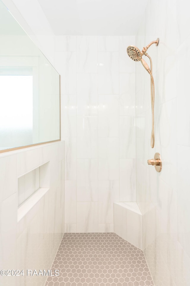 bathroom with a tile shower