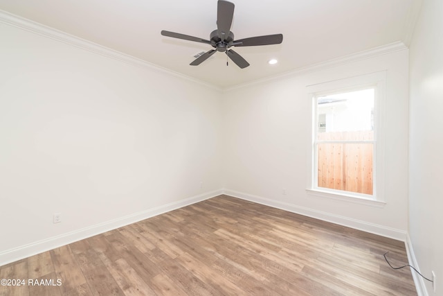 empty room with ceiling fan, ornamental molding, and light hardwood / wood-style flooring