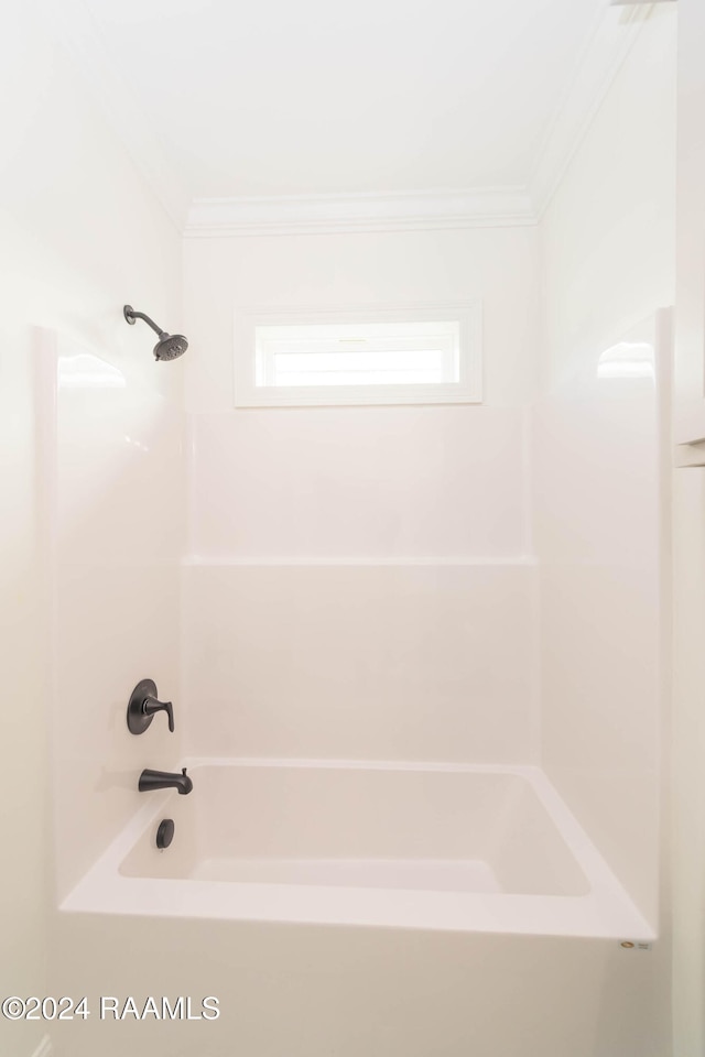 bathroom featuring  shower combination and ornamental molding