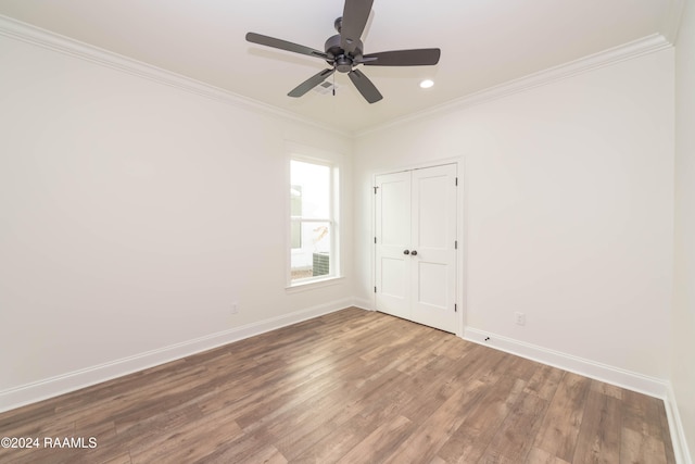 empty room with hardwood / wood-style flooring, ceiling fan, and crown molding