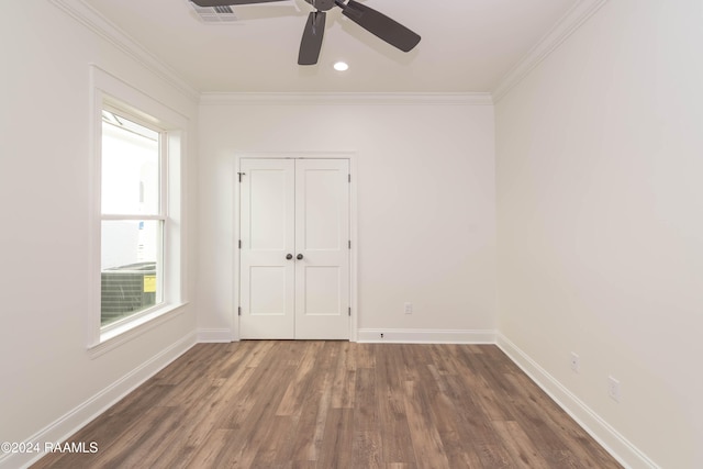 unfurnished room featuring ceiling fan, dark hardwood / wood-style flooring, and ornamental molding