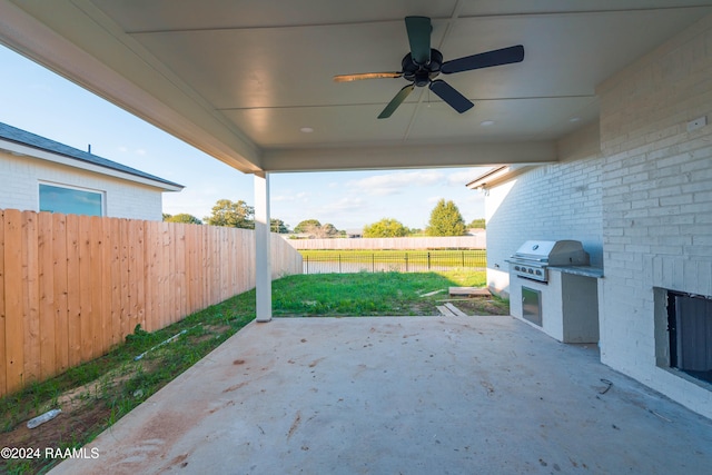 view of patio / terrace with an outdoor kitchen, ceiling fan, and a grill