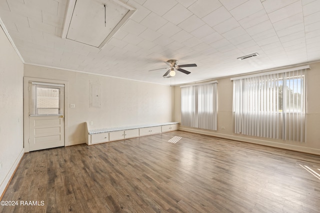 empty room featuring ceiling fan, hardwood / wood-style flooring, and crown molding