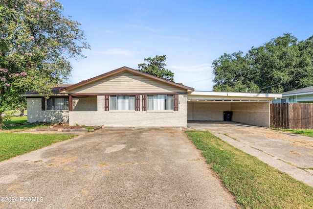 ranch-style house featuring a carport