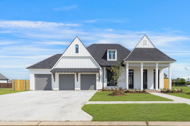 modern farmhouse with a front yard and a porch