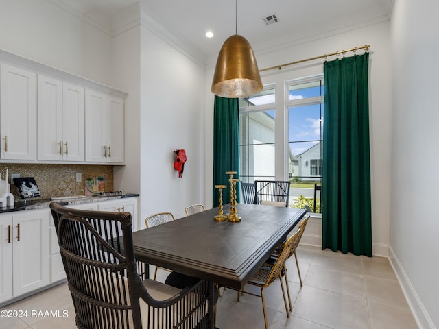 tiled dining area featuring ornamental molding