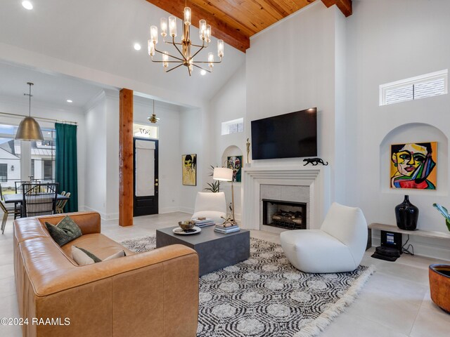 tiled living room featuring high vaulted ceiling, a fireplace, beamed ceiling, and a notable chandelier