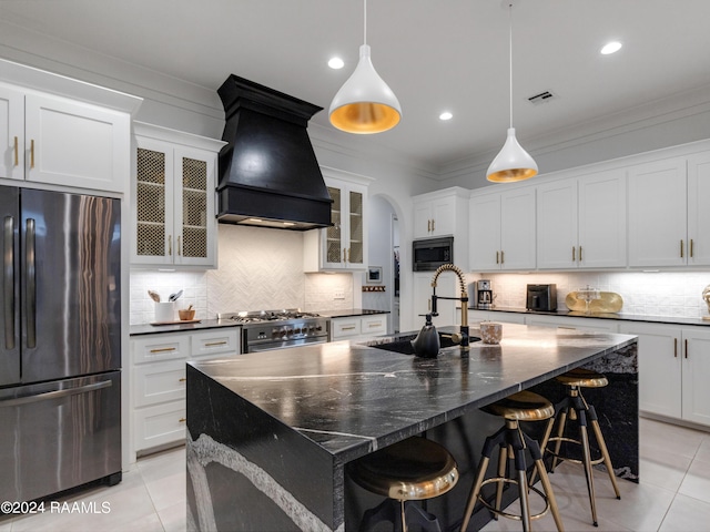 kitchen featuring light tile patterned floors, freestanding refrigerator, a sink, built in microwave, and premium range hood