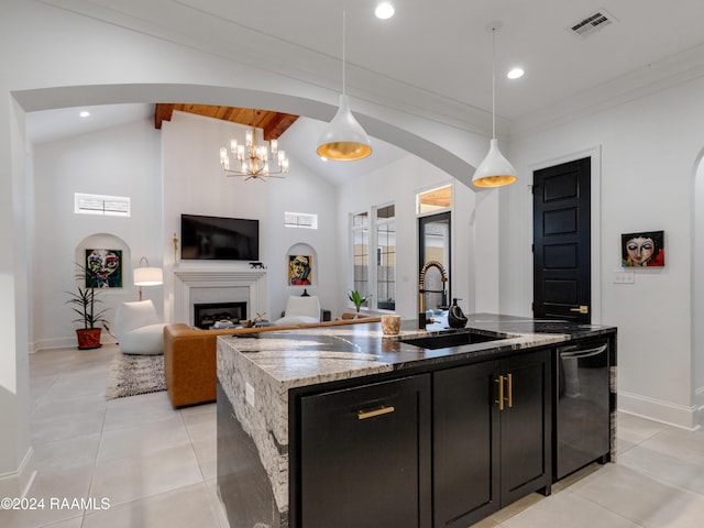 kitchen with arched walkways, dark cabinets, vaulted ceiling with beams, a fireplace, and a sink