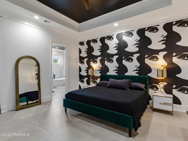 bedroom featuring light tile patterned flooring, a raised ceiling, ceiling fan, and connected bathroom