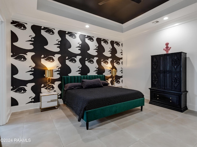 bedroom featuring light tile patterned floors, a tray ceiling, and baseboards