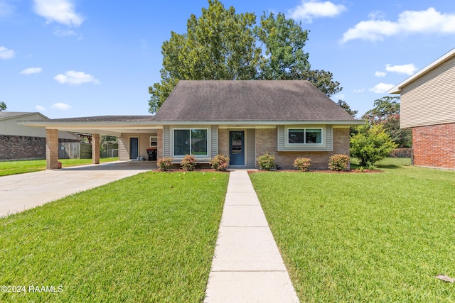 view of front of property with brick siding, a shingled roof, a front lawn, concrete driveway, and a carport