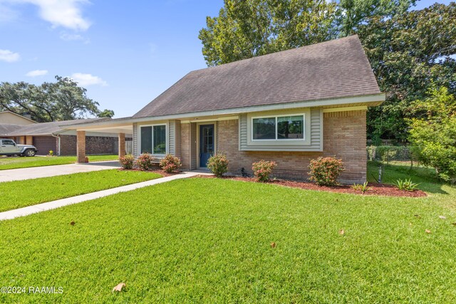 view of front facade with a carport and a front yard