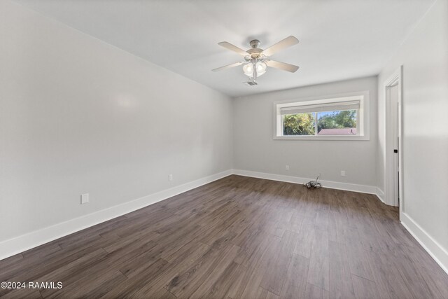 unfurnished room featuring ceiling fan and dark hardwood / wood-style flooring