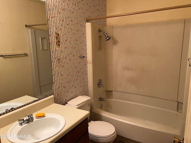 full bathroom with washtub / shower combination, vanity, and toilet