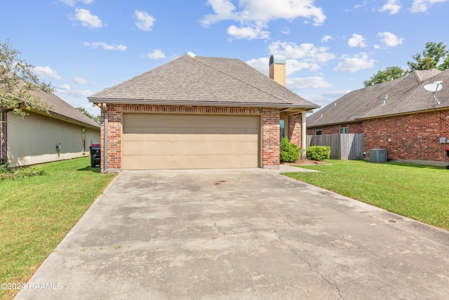 view of front of property featuring central AC, a front lawn, and a garage