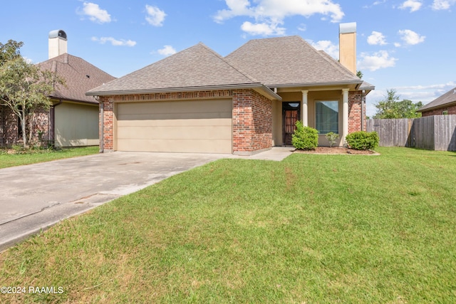 view of front facade with a garage and a front lawn