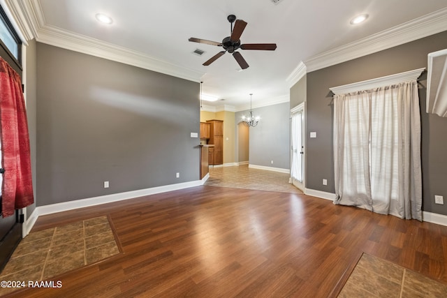 interior space featuring ceiling fan with notable chandelier, crown molding, and dark wood-type flooring