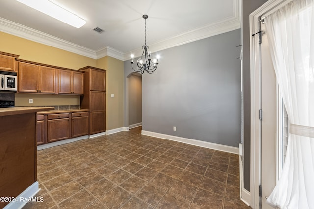 kitchen featuring a chandelier, decorative light fixtures, and crown molding