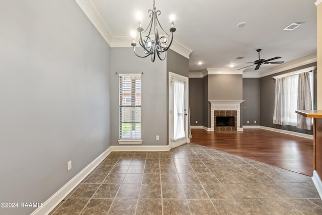 unfurnished living room featuring ornamental molding, ceiling fan with notable chandelier, hardwood / wood-style floors, and a tile fireplace