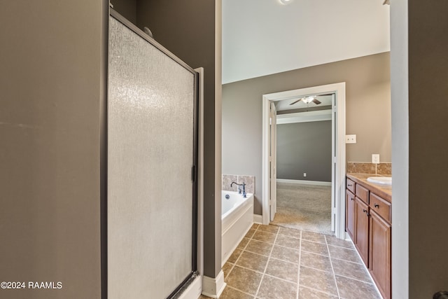 bathroom with shower with separate bathtub, tile patterned flooring, ceiling fan, and vanity