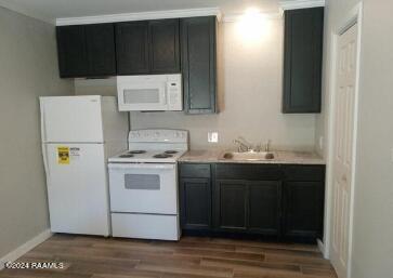 kitchen with sink, hardwood / wood-style floors, and white appliances