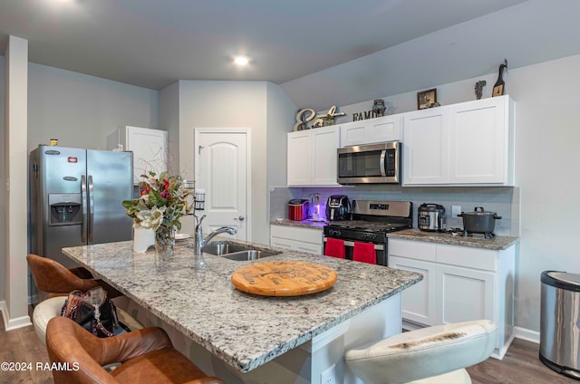 kitchen with white cabinetry, appliances with stainless steel finishes, dark wood-type flooring, and backsplash