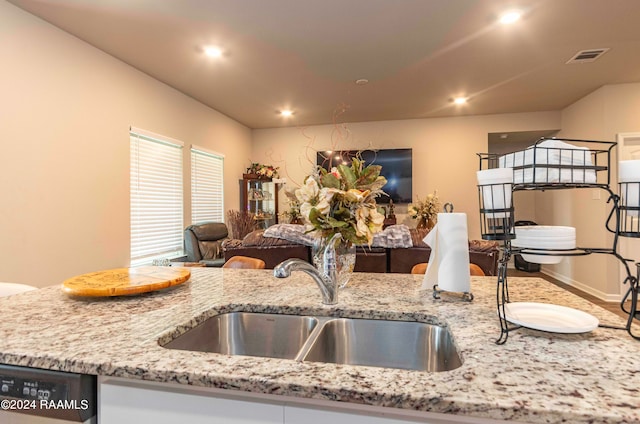 kitchen featuring sink, dishwasher, and hardwood / wood-style floors