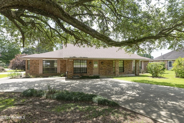 201 S Michot Rd, Lafayette, LA 70508 - ranch-style house featuring brick siding, a front yard, driveway, and roof with shingles