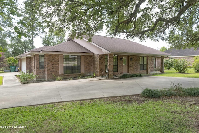 201 S Michot Rd, Lafayette, LA 70508 - ranch-style home with driveway, a front yard, brick siding, a garage, and a shingled roof