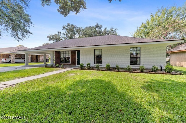 ranch-style house featuring a front yard and a carport