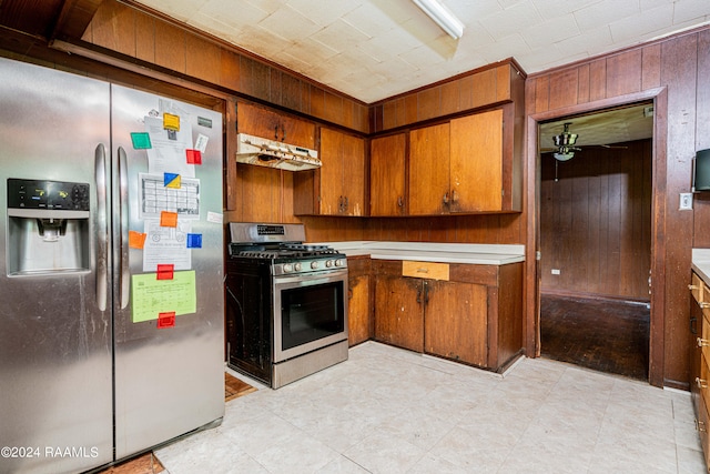 kitchen featuring appliances with stainless steel finishes and wooden walls